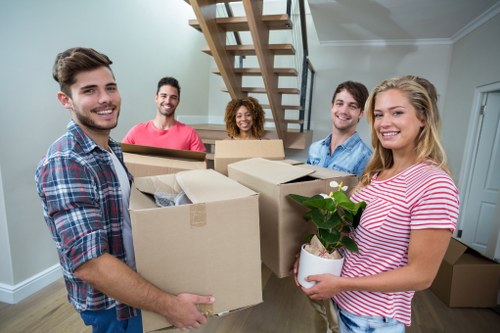 Local removals team handling a move in a Lambeth street with residential properties