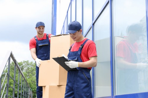 Moving team handling packed boxes during a home move in Lambeth