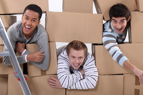 Team handling heavy item with careful lifting technique